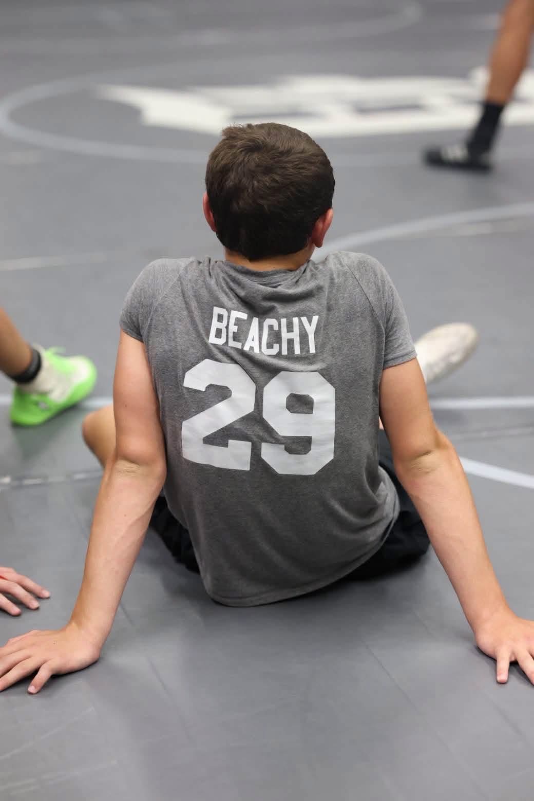 Nathan Beachy wearing his Beachy 29 team shirt beside the mat