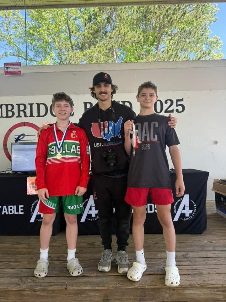 Nathan Beachy with his coach and teammate after a tournament